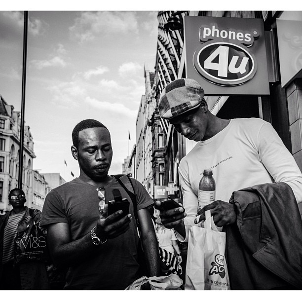 Phones for us. #london#londonpop #london_only #ig_uk #ig_london #bnw_city #bnw_london #bw #bnw #blackandwhite #street #streetphoto #streetphotography #streetphotography_bw #igerslondon #igers_london #oxfordstreet